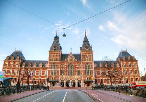Amsterdam, The Netherlands - April 16, 2015: Netherlands national museum with people in Amsterdam. The Rijksmuseum is dedicated to arts and history in Amsterdam.